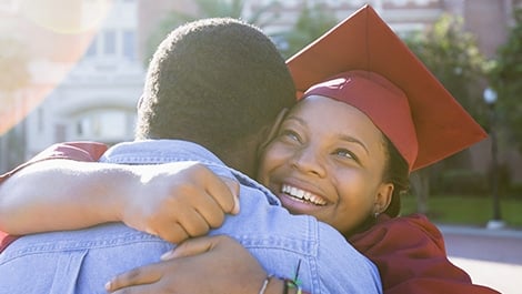 Graduate hugging loved one