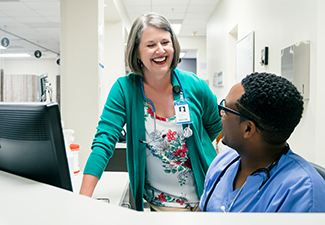 Two Nurses Interacting Happily