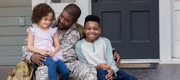 U.S. military father hugging children